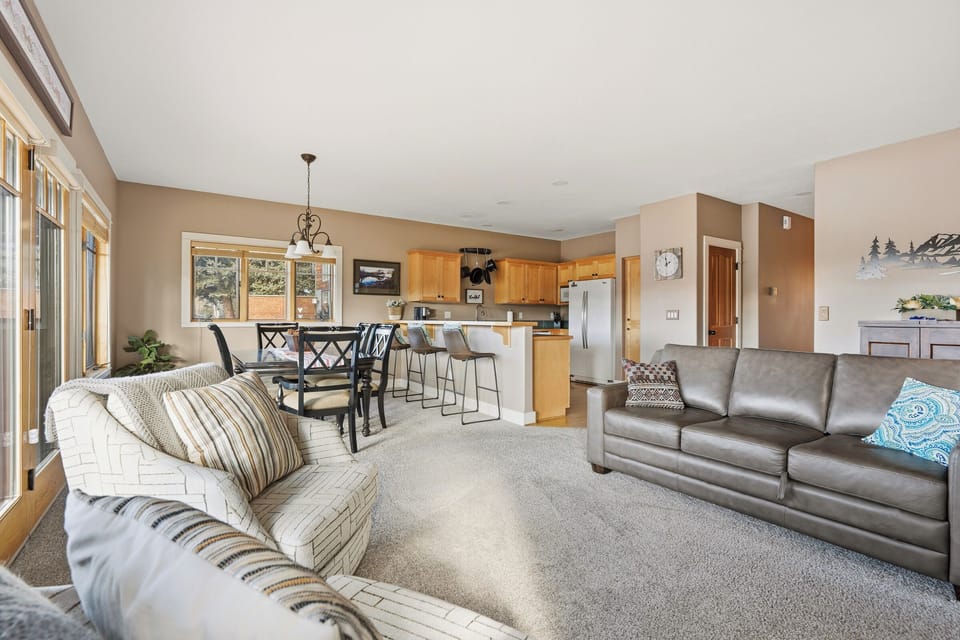 Relax in this spacious open-concept living area where comfortable sofas invite you to unwind after your mountain adventures.