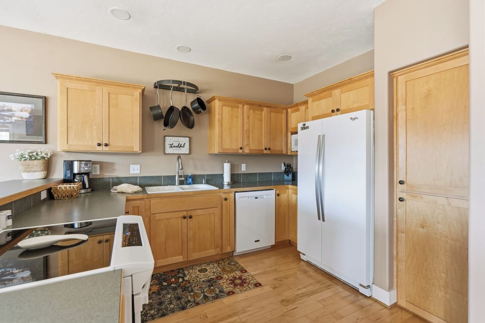 Your fully equipped kitchen awaits with warm wood cabinets, modern appliances, and everything needed to create memorable meals during your stay.