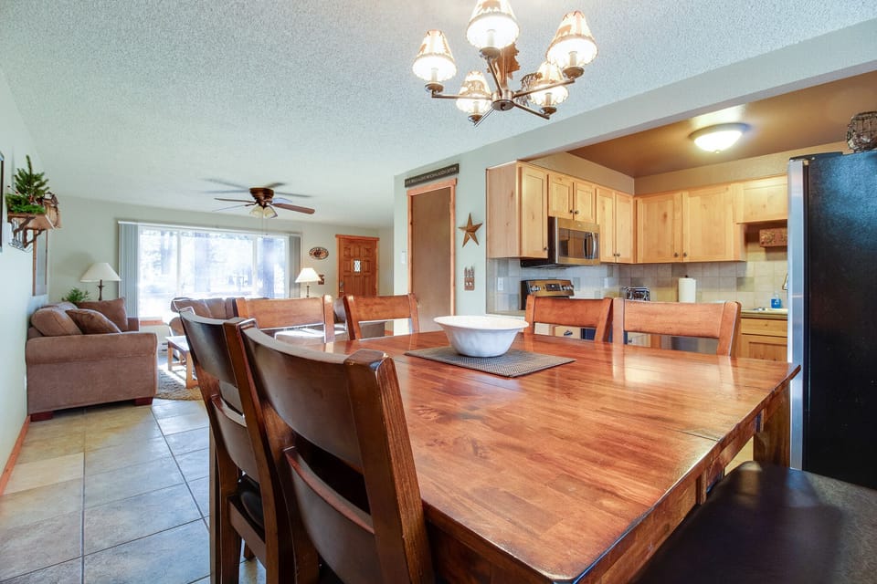 Gather around the warm wooden table where your group can share meals and stories. The open layout connects the fully-equipped kitchen with a cozy living area—perfect for relaxing together after a day of adventure.