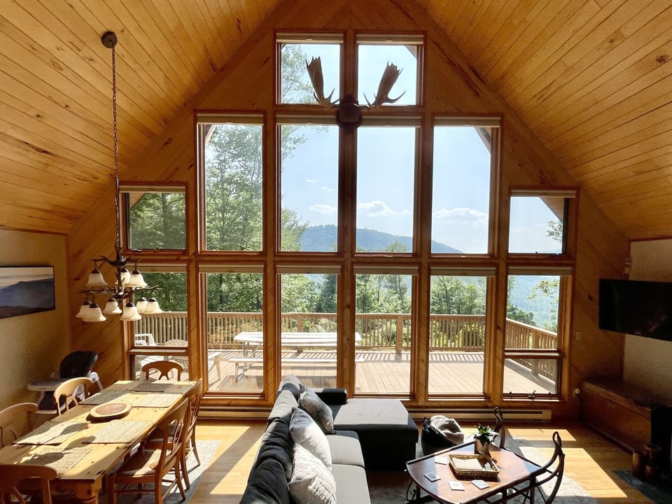 Cozy living room with fireplace and floor-to-ceiling mountain views
