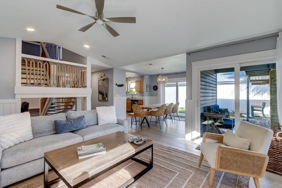 Spacious Living Area Featuring a Comfortable Sofa, Loveseat, and Flat Screen Smart TV