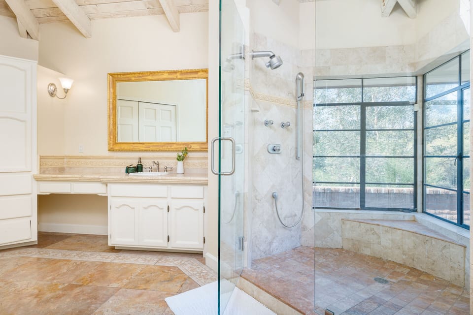 Primary bedroom's ensuite features a large shower with views.