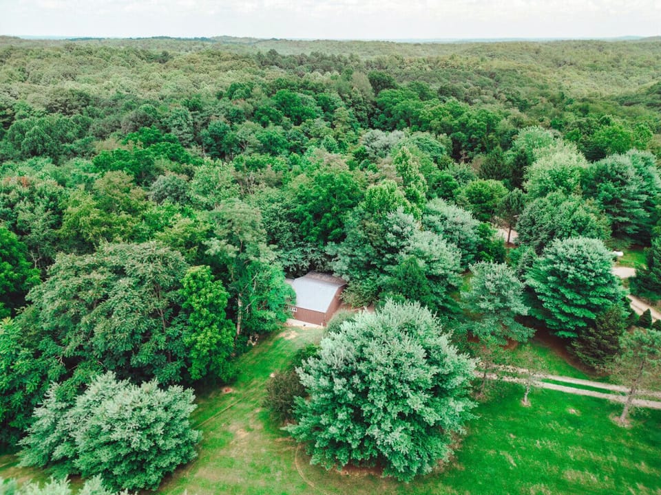 Aerial forest view highlights the secluded cabin setting for a quiet Hocking Hills couples retreat