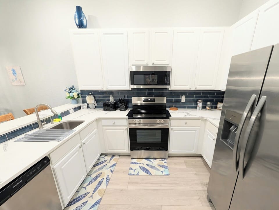 Bright, Fully Equipped Kitchen with Stainless Steel Appliances