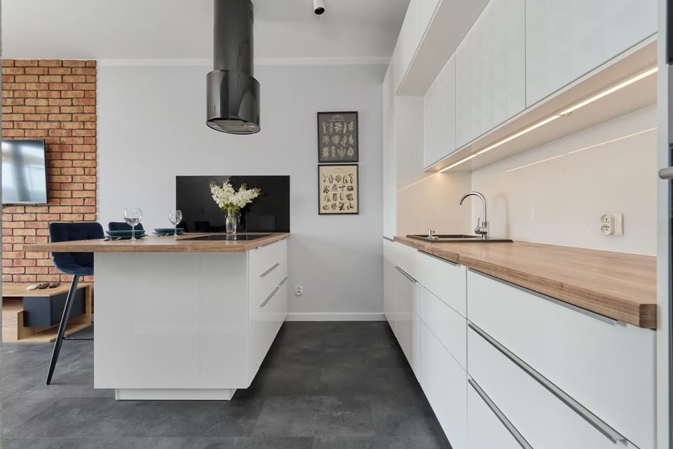 The sleek design of the kitchenette blending seamlessly with the living area.
