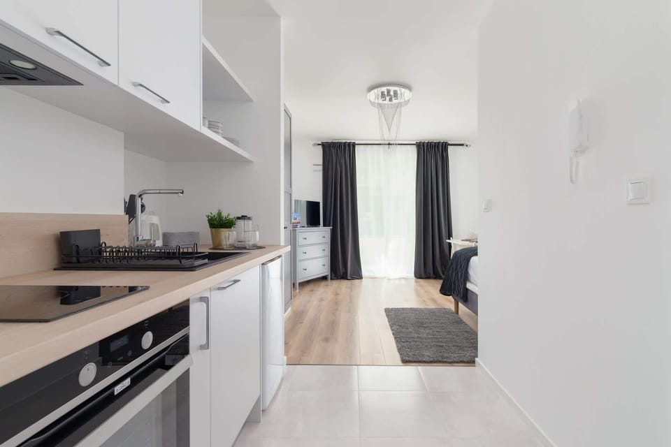 The sleek design of the kitchenette blending seamlessly with the living area.