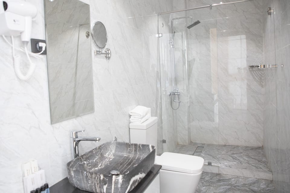 Deluxe Double Room | Bathroom | Rainfall showerhead, designer toiletries, hair dryer, slippers