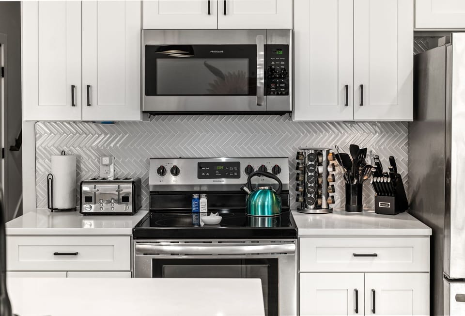 Well stocked kitchen with quartz countertops.  Spice rack, oil and cooking essentials .