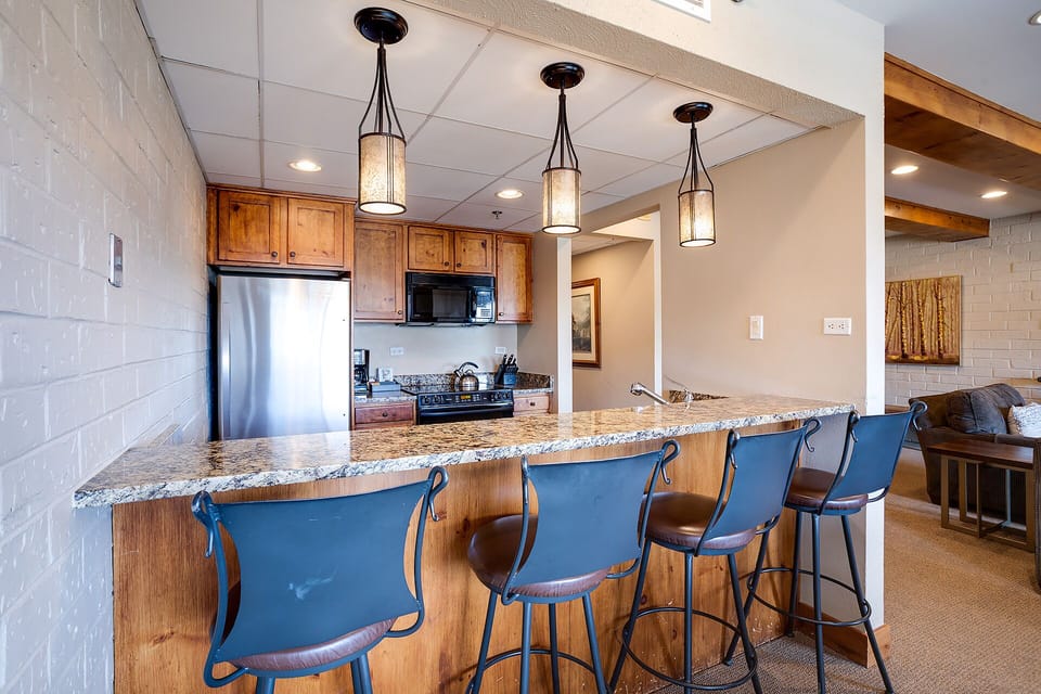 Your fully equipped kitchen features granite counters, stainless appliances, and a breakfast bar where you can start each morning with coffee.