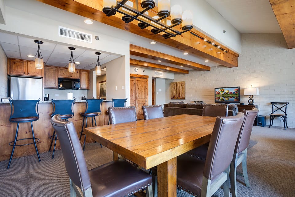 You'll love gathering around this stunning rustic dining table while the open kitchen makes meal prep a breeze.
