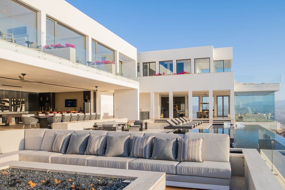 Poolside with incredible ocean and city views at night