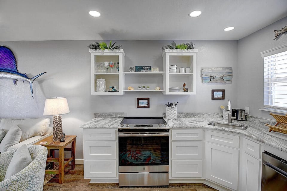 Cook your favorite meals in this bright, fully-equipped kitchen with gleaming granite counters and coastal touches that make you feel right at home.