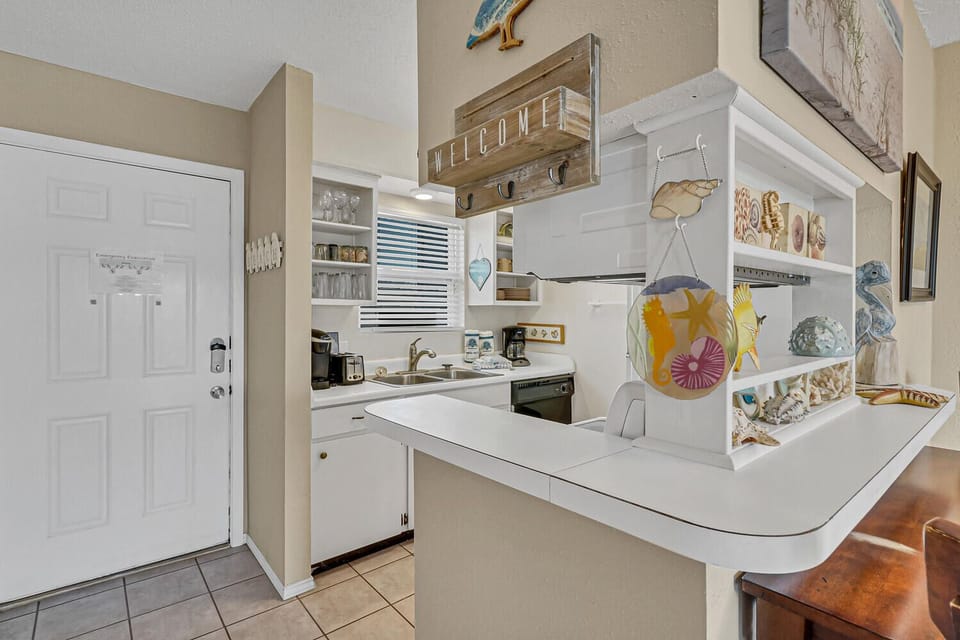 Your fully equipped kitchen awaits with coastal charm and everything needed to prepare memorable meals during your stay.