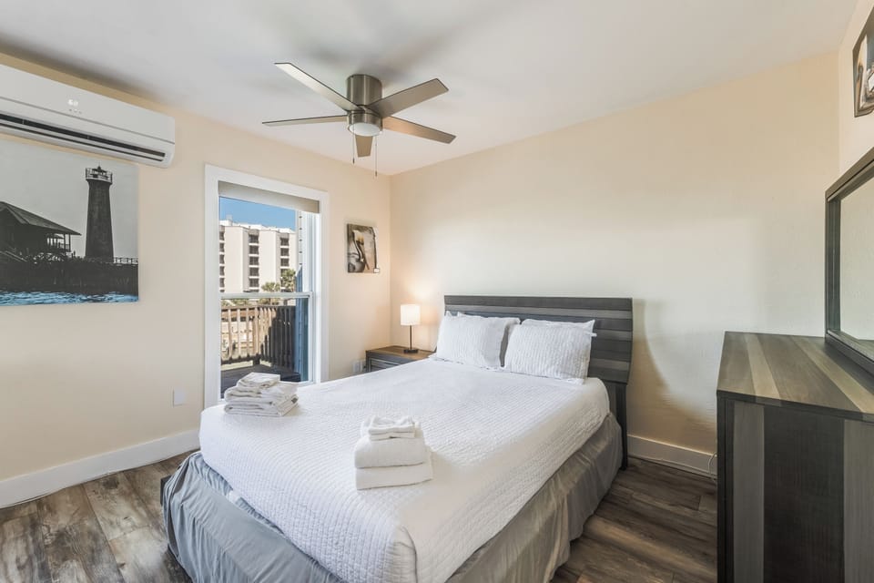 Unwind in your peaceful bedroom with crisp linens, gentle ceiling fan, and air conditioning for perfect comfort year-round.