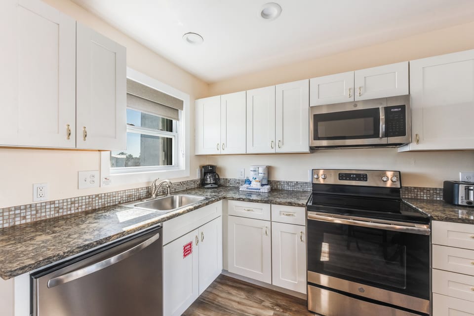 Your fully equipped kitchen awaits with granite counters, stainless appliances, and everything needed to create memorable meals during your stay.