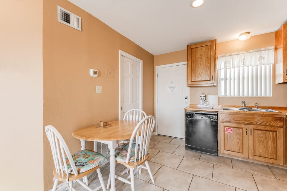 Your cozy kitchen and dining space invites home-cooked meals with warm wood cabinets, modern appliances, and a charming breakfast nook.