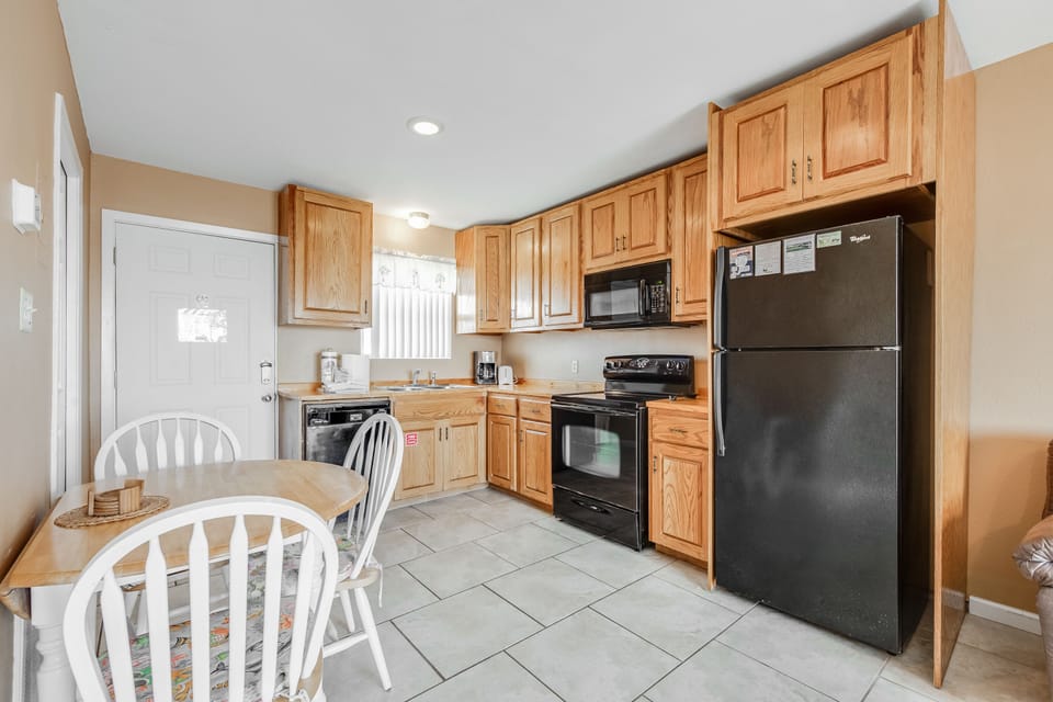 Your fully equipped kitchen features warm oak cabinets, modern appliances, and a cozy dining nook for memorable meals together.
