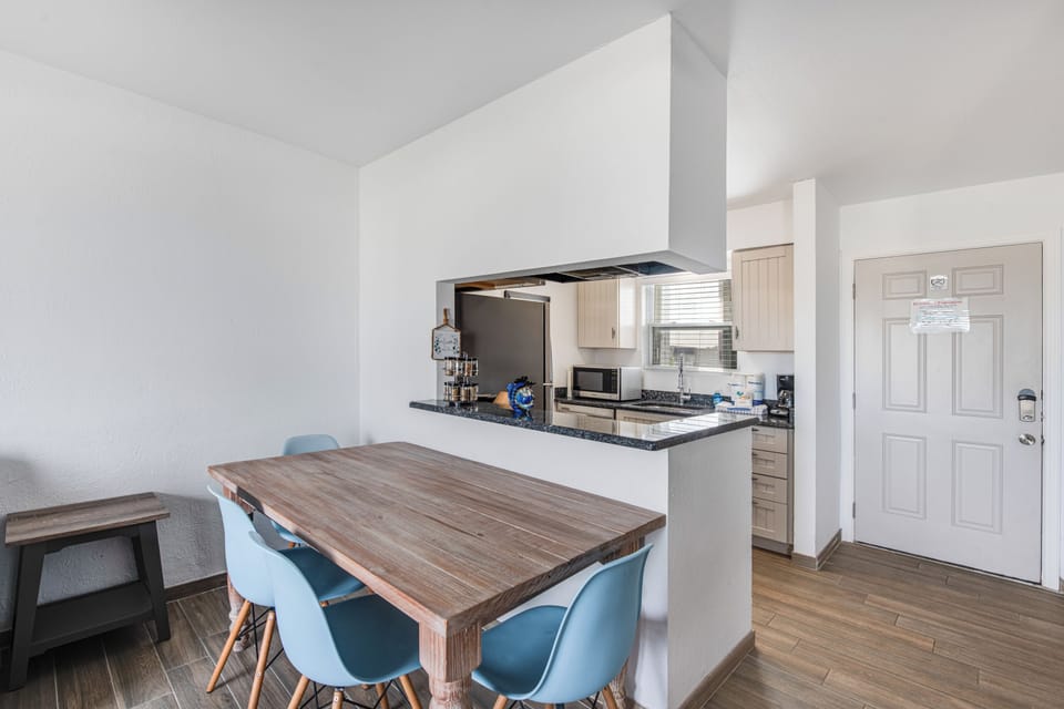 Your open-concept kitchen flows seamlessly into the dining space, where warm wood tones meet modern appliances for effortless meal prep.