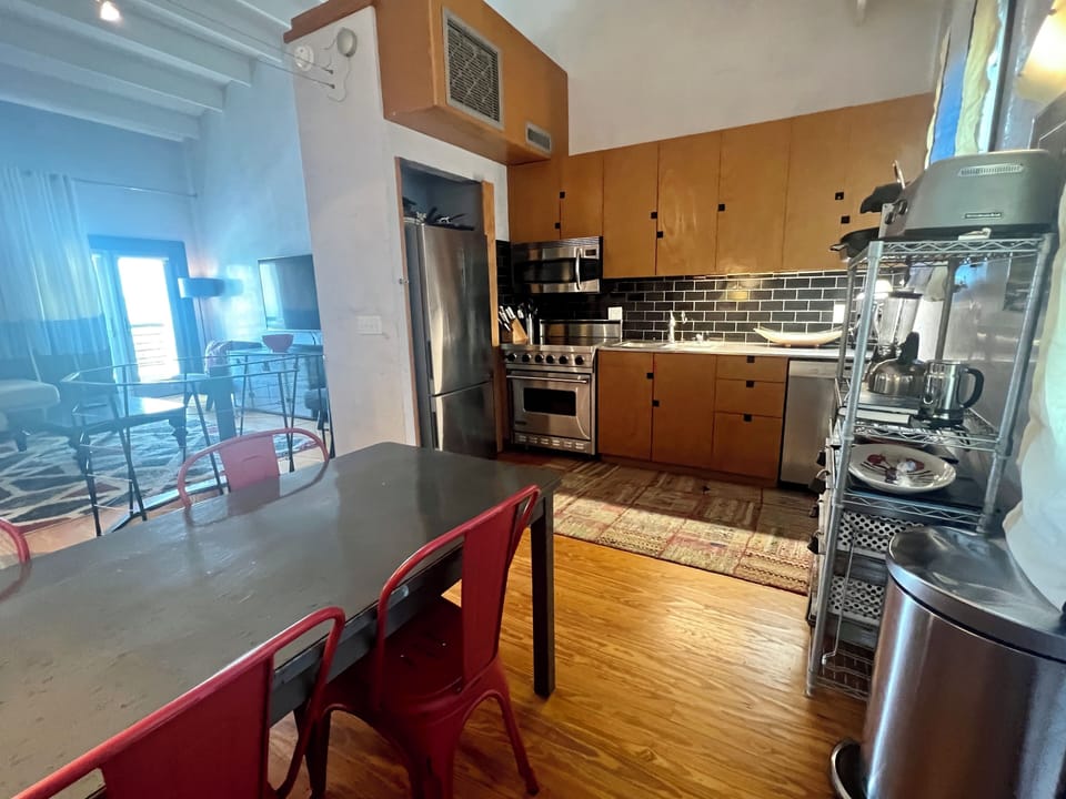 FULLY EQUIPPED KITCHEN AND DINING AREA ON SECOND LEVEL