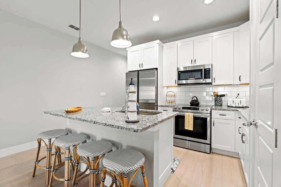 Kitchen next to Living room with Stainless Steel Appliances