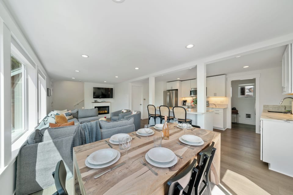 Dining room open to Living room with electric fireplace, Streaming TV, and kitchen with Bar seating.