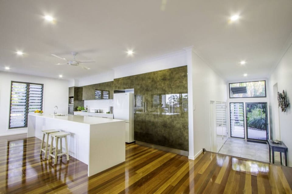 Modern kitchen with fridge, oven, stove, microwave, and dishwasher. Fully equipped for family meals.