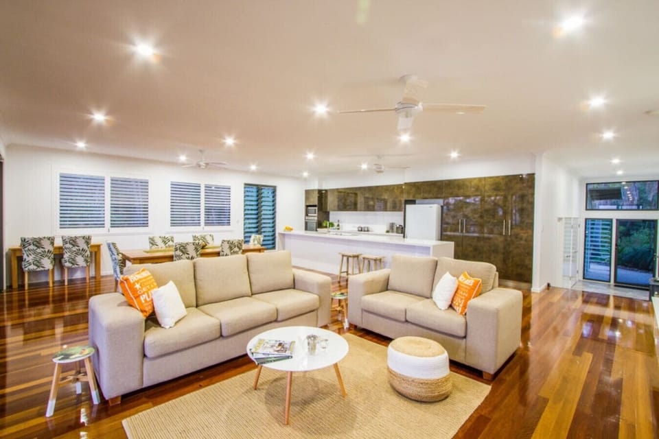 Open‑plan living, dining, and kitchen with balcony access. Bright, functional space for guests.