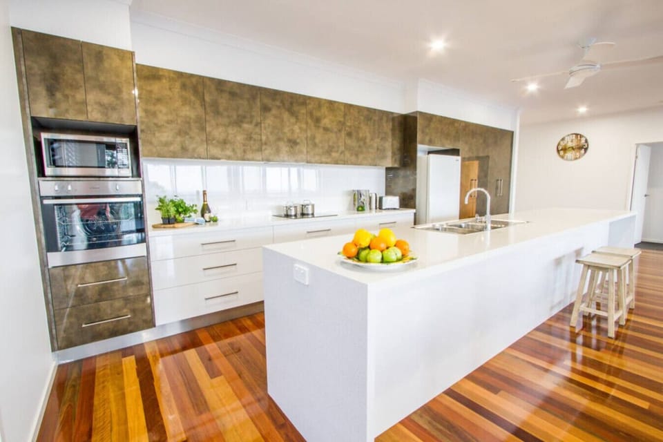 Modern kitchen with fridge, oven, stove, microwave, and dishwasher. Fully equipped for family meals.