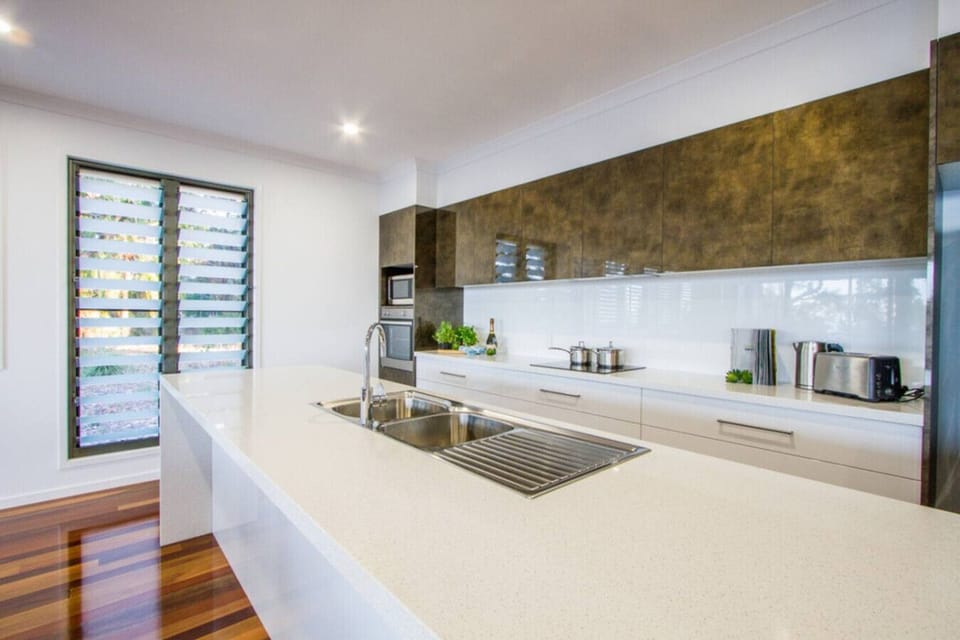 Modern kitchen with fridge, oven, stove, microwave, and dishwasher. Fully equipped for family meals.