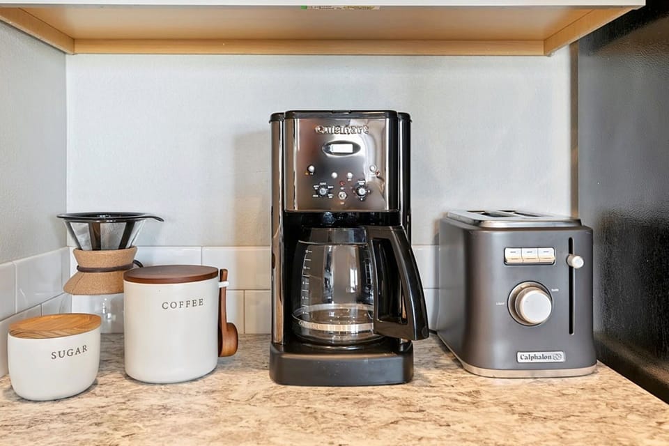 Coffee Station with a drip coffee maker and a pour-over.  Coffee, creamer and sugars provided.