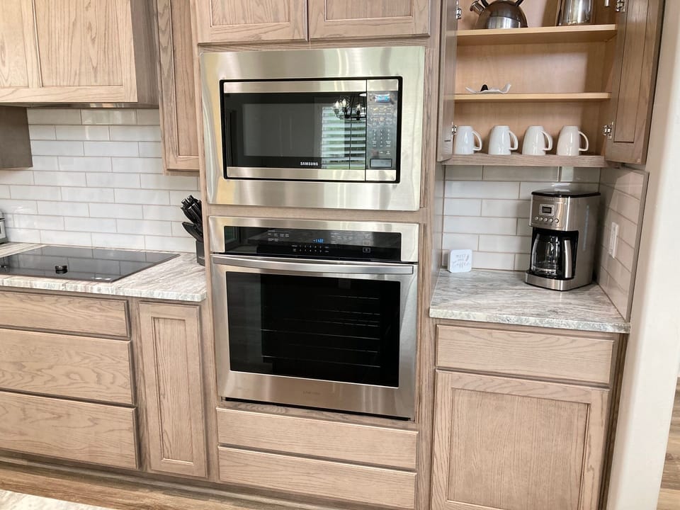 Microwave on top and oven below; coffee bar to the side