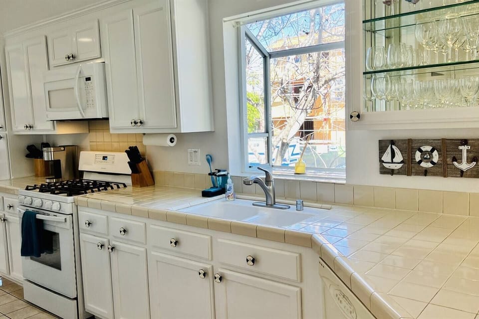 Kitchen features gas stovetop, microwave, oven, and Keurig