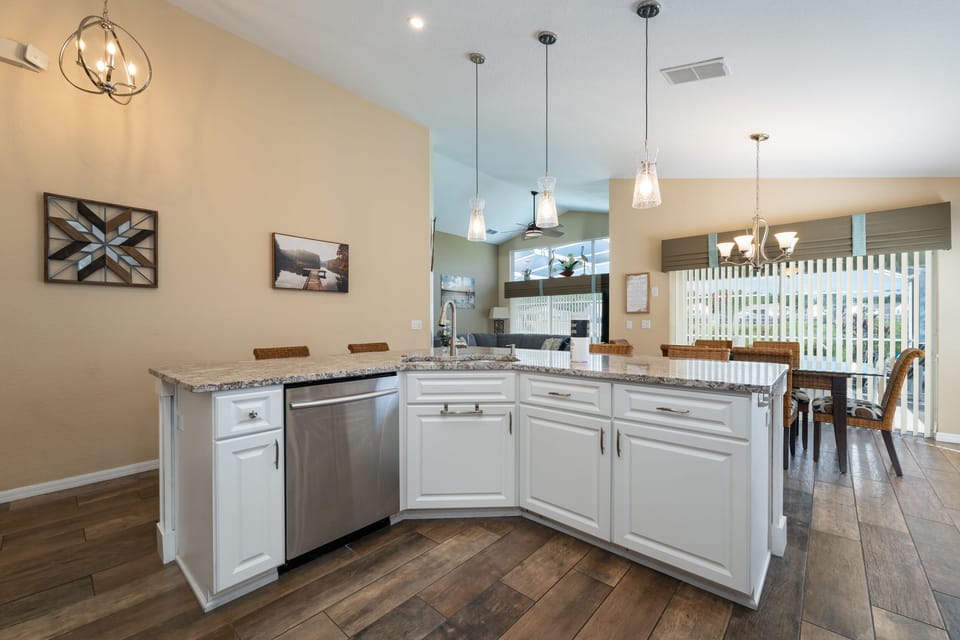 Center island in the kitchen has sink and dishwasher.