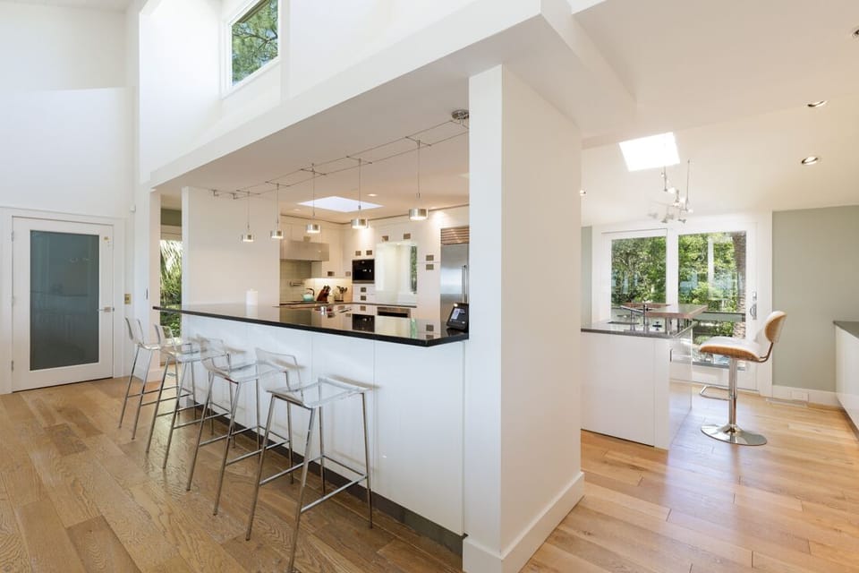 Generous counter seating, pendant lighting, and hardwood floors create a warm, inviting atmosphere for everyday living and entertaining.