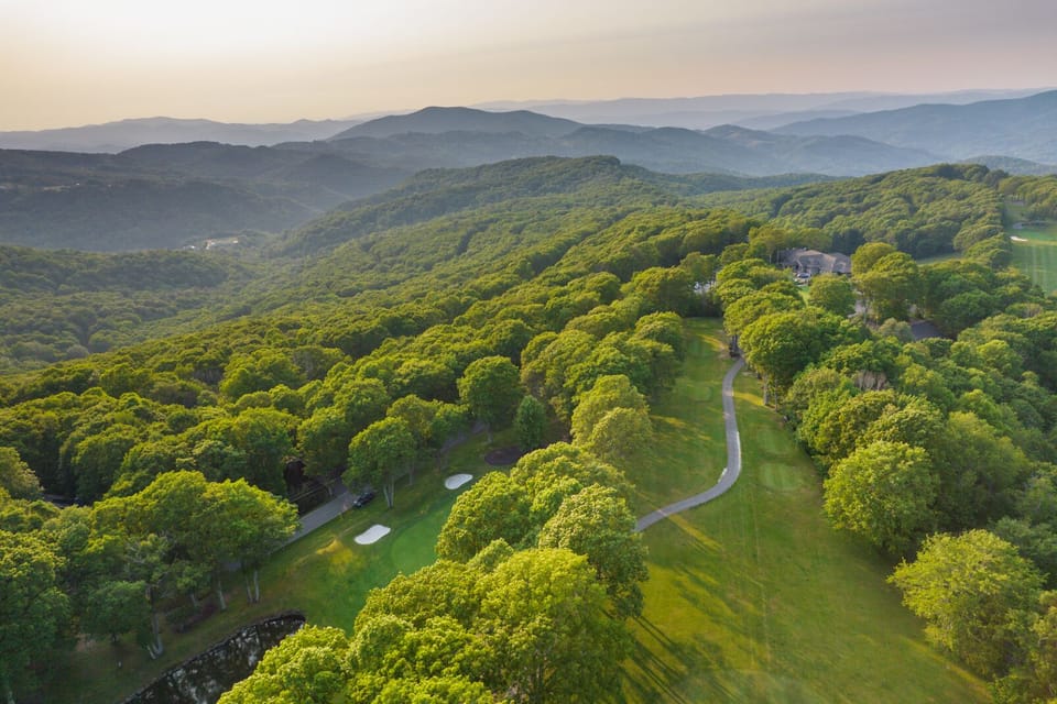 Aerial view of golf course and mountain range