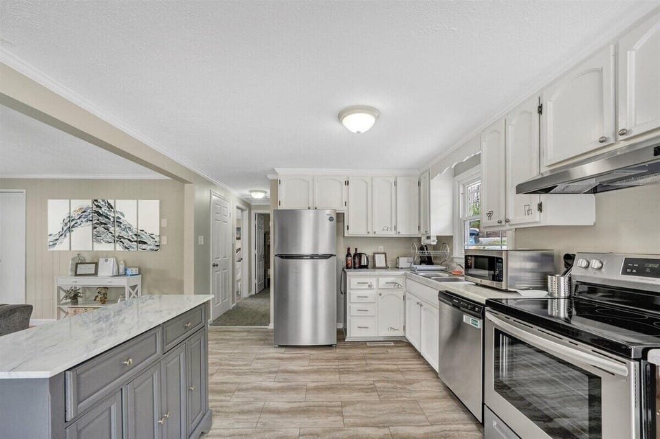 Fully equipped kitchen with stainless steel appliances and ample counter space for meal prep
