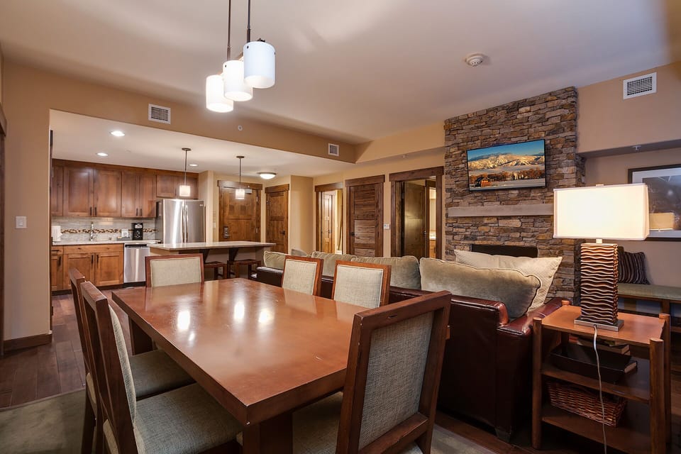 Gather around the elegant dining table while your group enjoys mountain views and modern comfort in this stylish open-concept space.