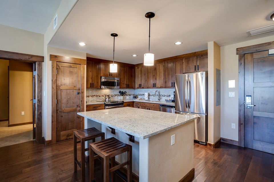 Your spacious kitchen features rich wood cabinetry, granite countertops, and modern stainless appliances for memorable meal prep.