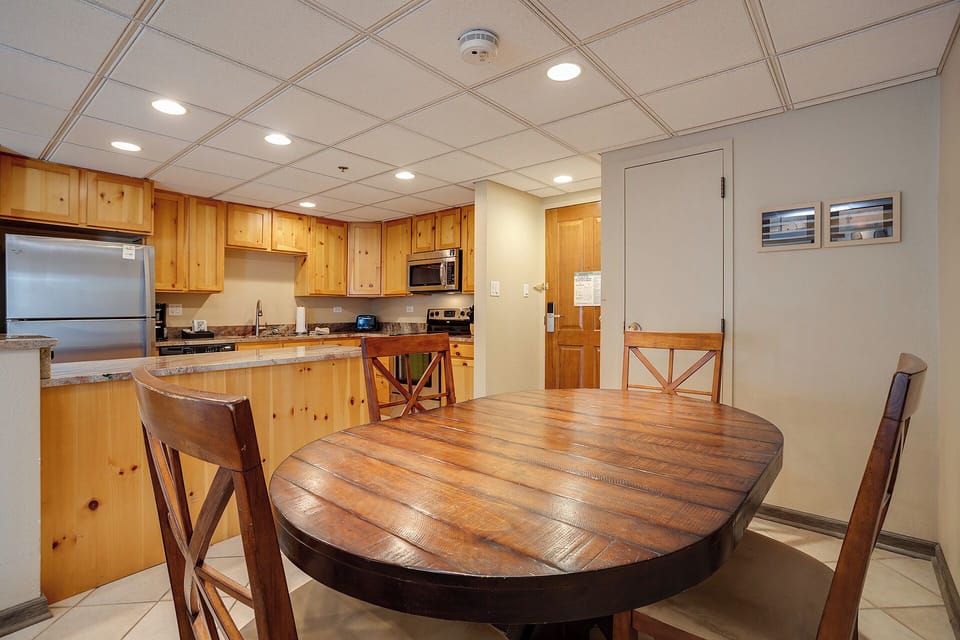 Your spacious kitchen features warm wood cabinets, granite counters, and a stunning round dining table perfect for memorable meals together.