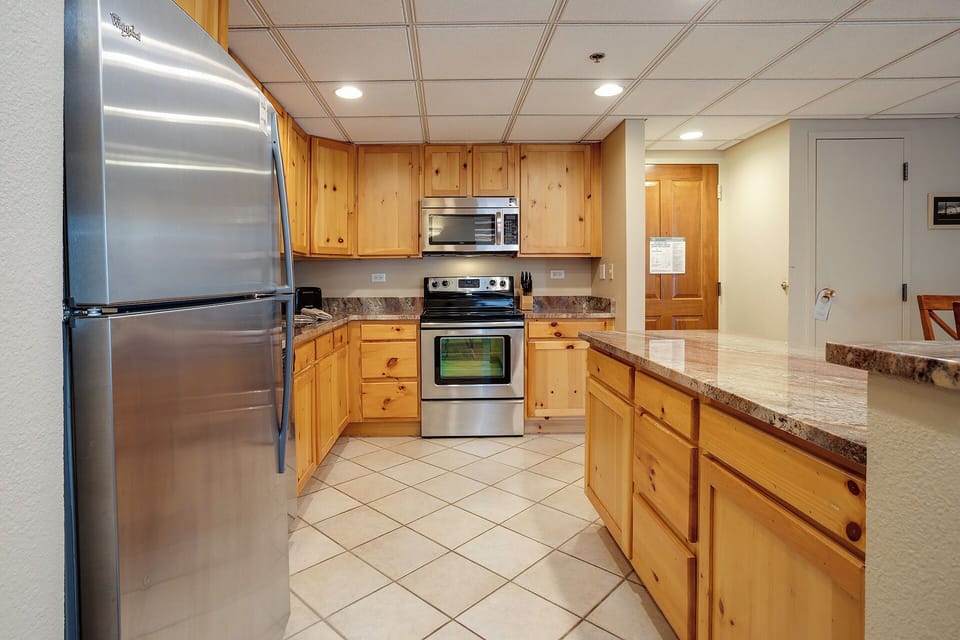 Your spacious kitchen features warm wood cabinets, granite countertops, and stainless steel appliances for memorable home-cooked meals.
