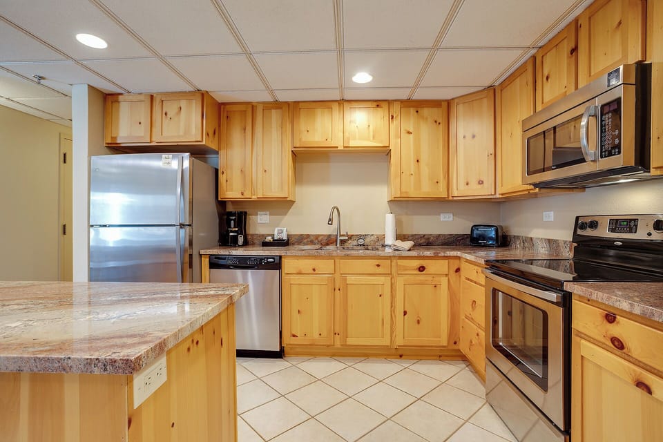 Your fully equipped kitchen features warm knotty pine cabinets, granite countertops, and stainless steel appliances—everything you need to create memorable meals.