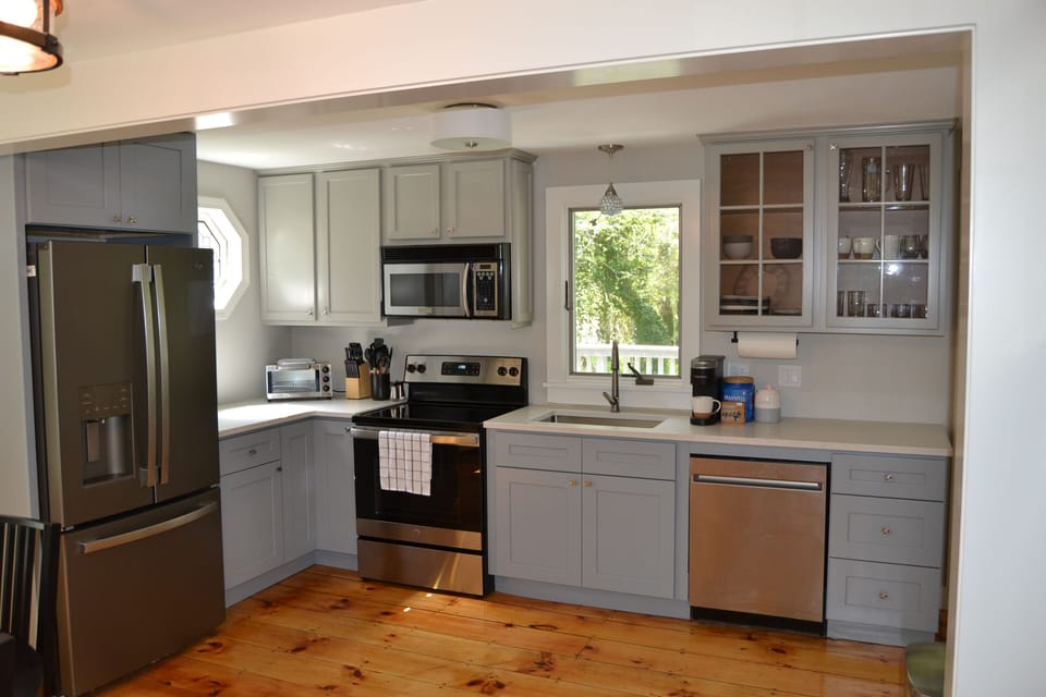 Updated full kitchen with new stainless steel appliances, countertops, and floor