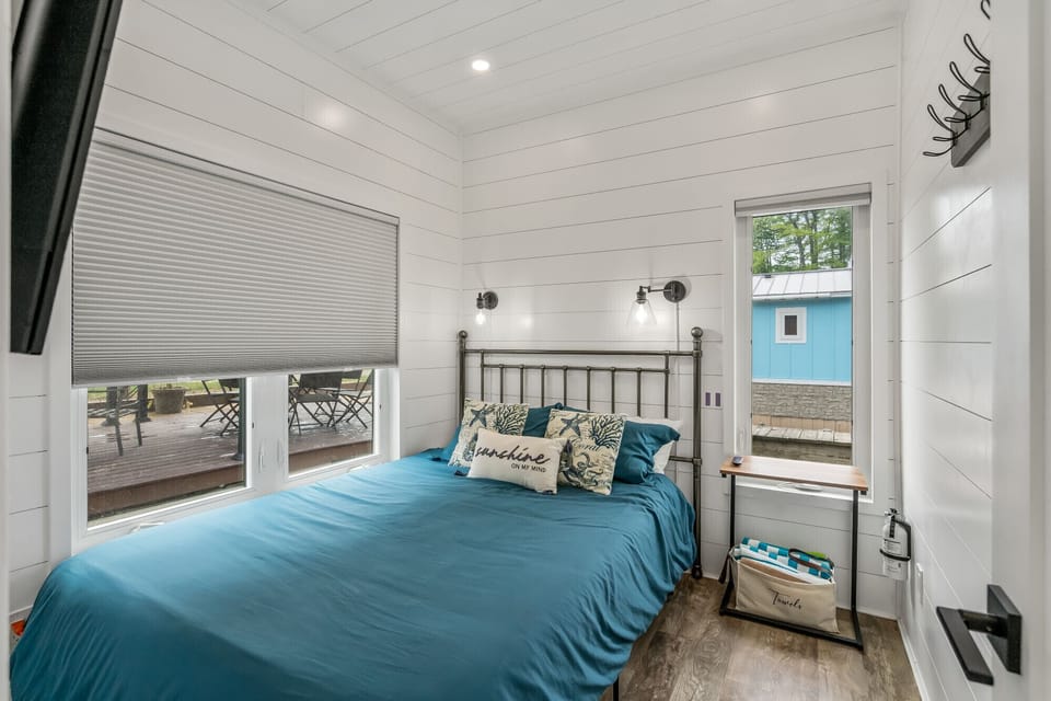 Wake up in this bright queen bedroom.