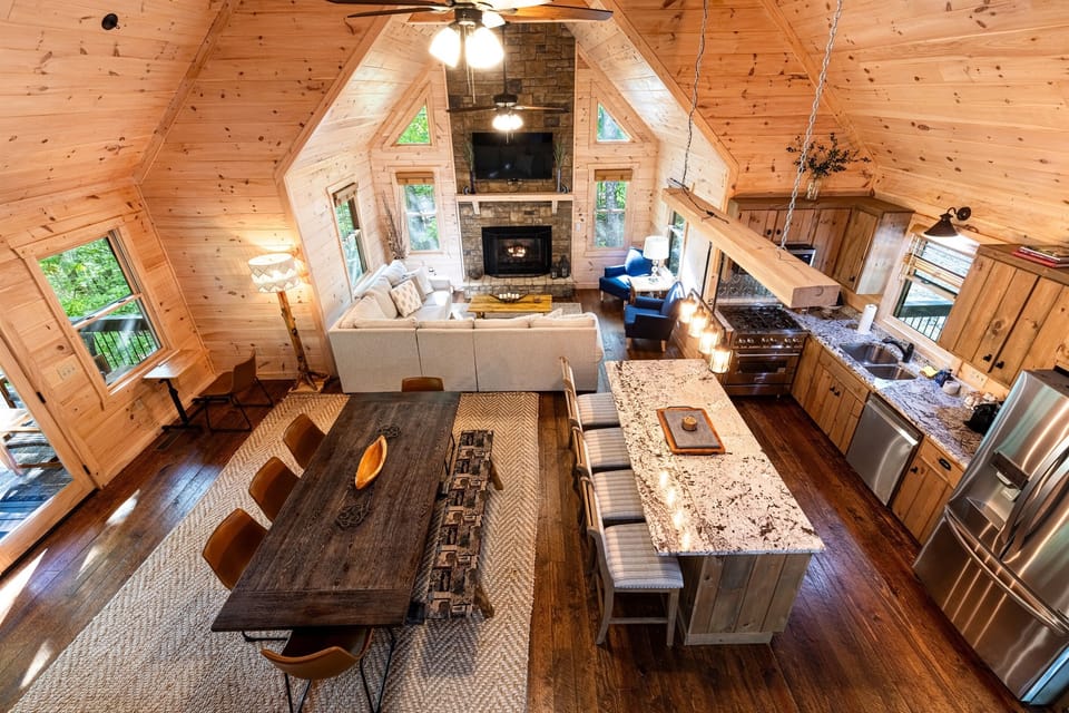Our main floor is a great spot for groups. You have an open concept with a kitchen, dining room, living room with T.V., main deck, half bathroom, and bedroom with ensuite.