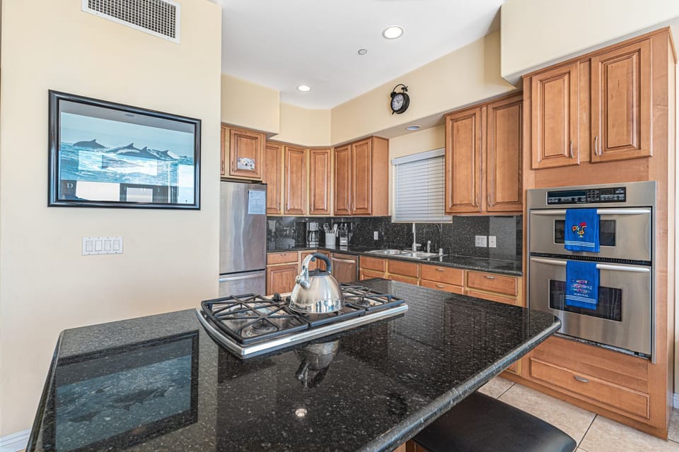 The kitchen comes stocked with dishes, utensils, cookware, bakeware, and all major and small appliances.
                