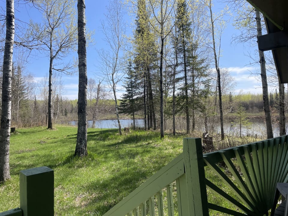 Covered front porch overlooks the West Bay of Long Lake