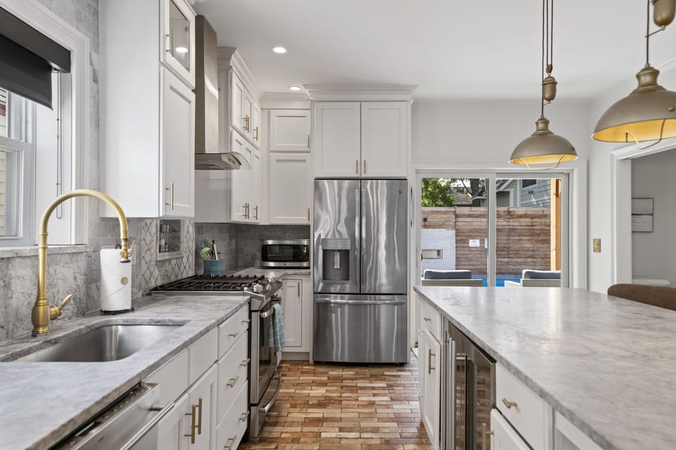 Kitchen with stainless steel appliances, dishwasher, and wine fridge