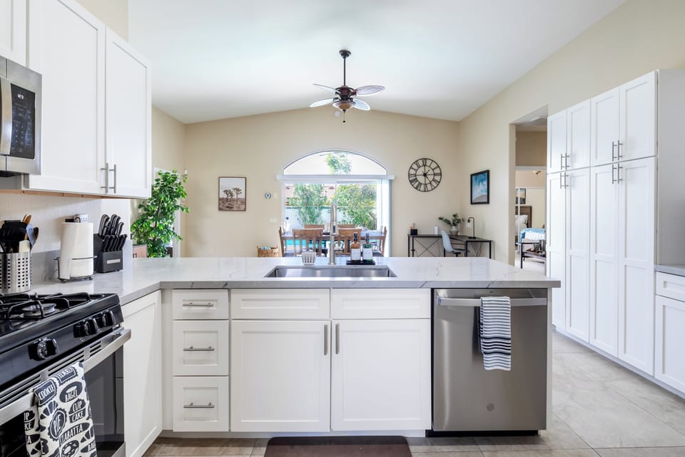 Kitchen sink/dishwasher with view of pool and San Jacinto mountains