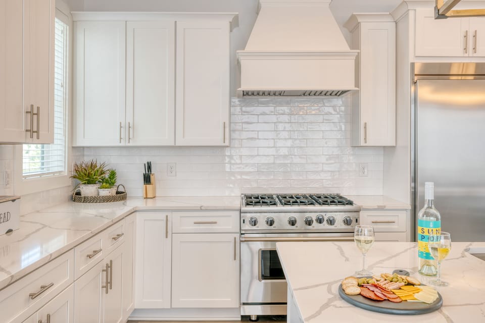 The fully-equipped kitchen features modern appliances, including a gas range.