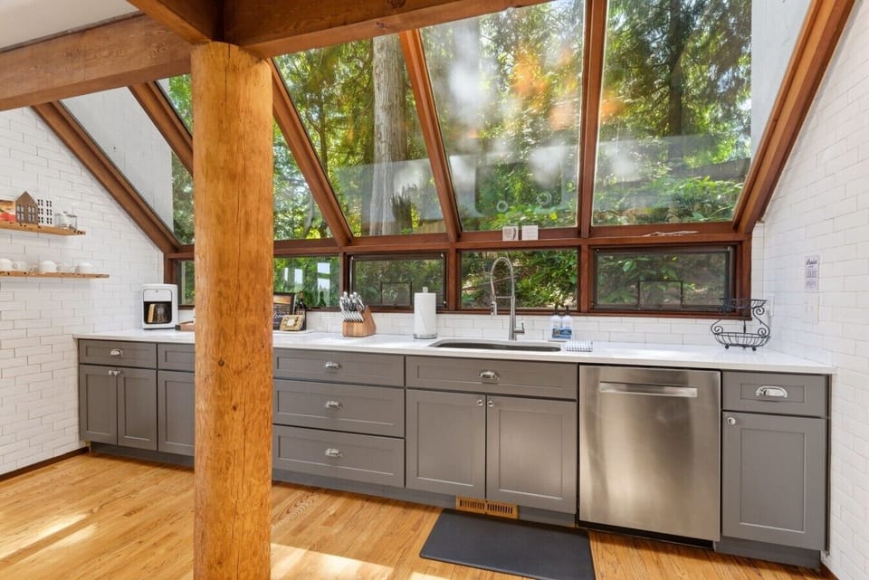 Stunning windows make you feel like you`re in nature while preparing family meals.